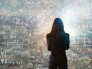 A set of complex equations on a whiteboard.