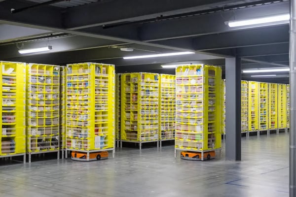 During a behind the scenes tour of an Amazon Fulfillment Center, robots move around on the "Dance Floor."