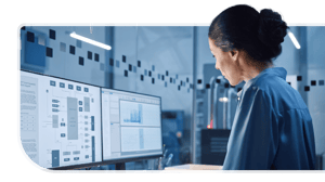 A systems engineer works on an IT transformation process at her desktop.