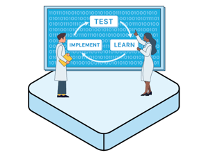 Icon representing testability with scientists in white coats standing in front of a screen that says test, learn and implement.