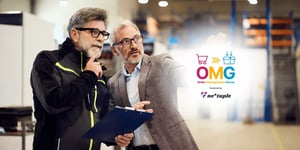 Two business leaders in a warehouse point to their b2b order management system