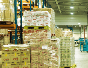 Pallets of various products stacked in a large wholesale club that modernized its inventory management system with OnePint.ai.