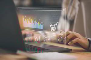 A person on a laptop looks at inventory availability levels.